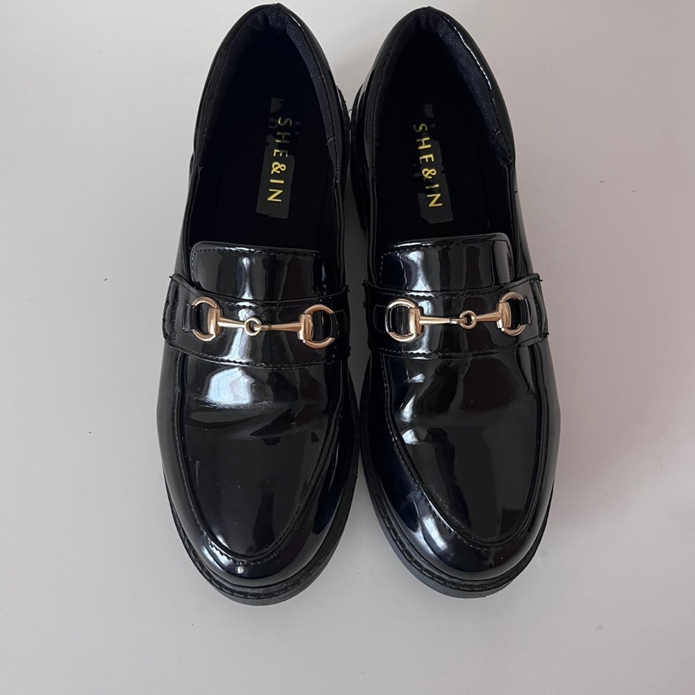 black loafer with gold buckle